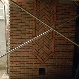 A photo of the decorative herringbone detail and the ash chute.