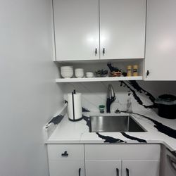 Manhattan Cabinets - Sink, refaced cabinets with new soft close drawers and new backsplash and countertop.