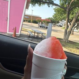 a hand holding a cup of shaved ice a hand holding a cup of shaved ice
