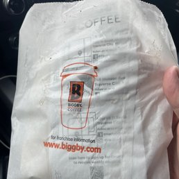 a person holding a bag of coffee a person holding a bag of coffee
