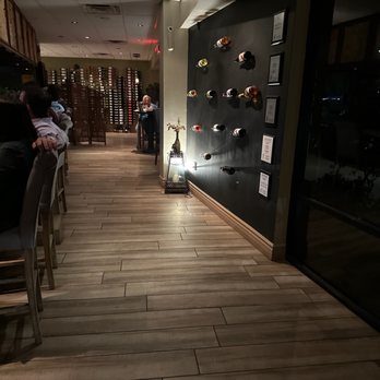 The Cellar - a row of wine glasses on the wall - Wine Bars Near Me - Ahwatukee, Arizona