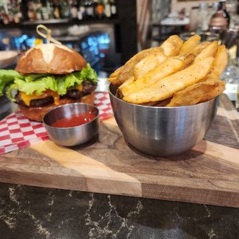District 102 - a burger with fries and ketchup - Canadian (New) Near Me - Edmonton, Alberta
