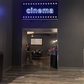 Jake's Unlimited - Cinema themed eating area with movie playing - Arcades Near Me - Mesa, Arizona