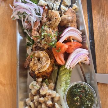 El Mono - Shrimp and chicken anticucho. It comes with a side of potato and corn. - Peruvian Near Me - Berkeley, California El Mono - Shrimp and chicken anticucho. It comes with a side of potato and corn. - Peruvian Near Me - Berkeley, California