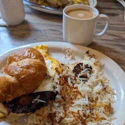 Sweet Basil - Croissant with eggs, cheese, sausage and hash browns.