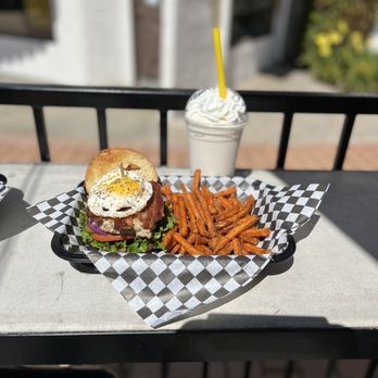 Grinderz - a burger and fries on a table - Burgers Near Me - Huntington Beach, California Grinderz - a burger and fries on a table - Burgers Near Me - Huntington Beach, California