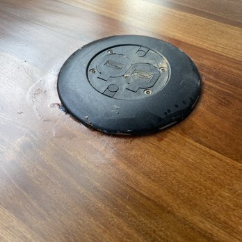 Gemini Floor Services - a black frisbee on a wood floor - Flooring Near Me - Brooklyn, New York