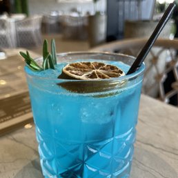 a blue drink with a spoon in it a blue drink with a spoon in it