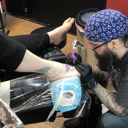 Union Station West Tattoo & Body Piercing - Jeremy at work.
