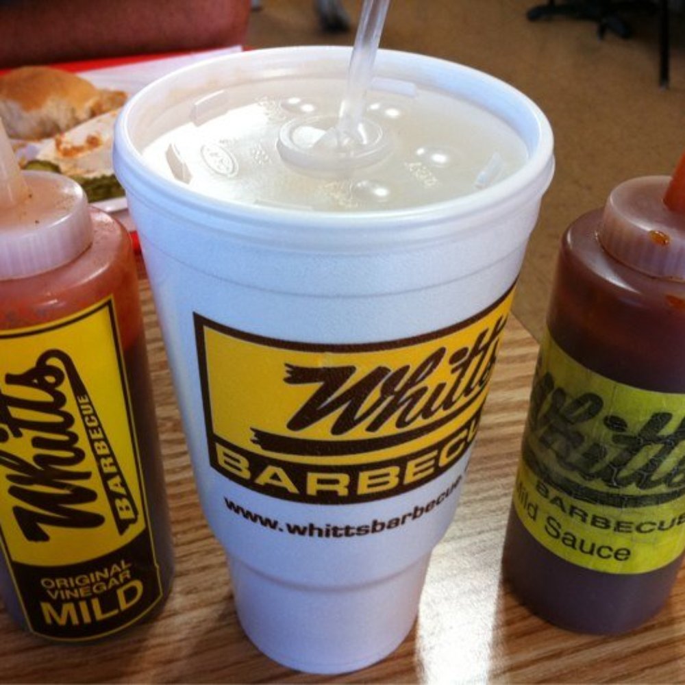 a cup of hot sauce and two bottles of ketchup a cup of hot sauce and two bottles of ketchup