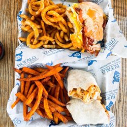El Bufalo Tequila Bar & Kitchen - Top: breakfast sandwich with curly fries, bottom: Nashville burrito with sweet potato fries