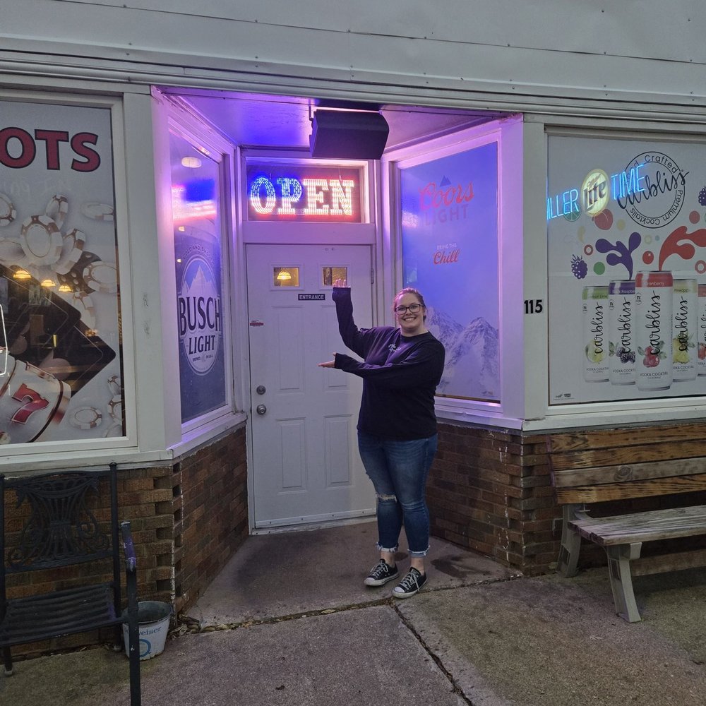 Manlius Tap - Owner, Ericka, showing off the new open sign. - Burgers Near Me - Manlius, Illinois