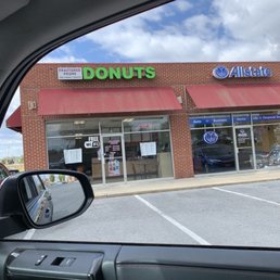 a donut shop in a parking lot