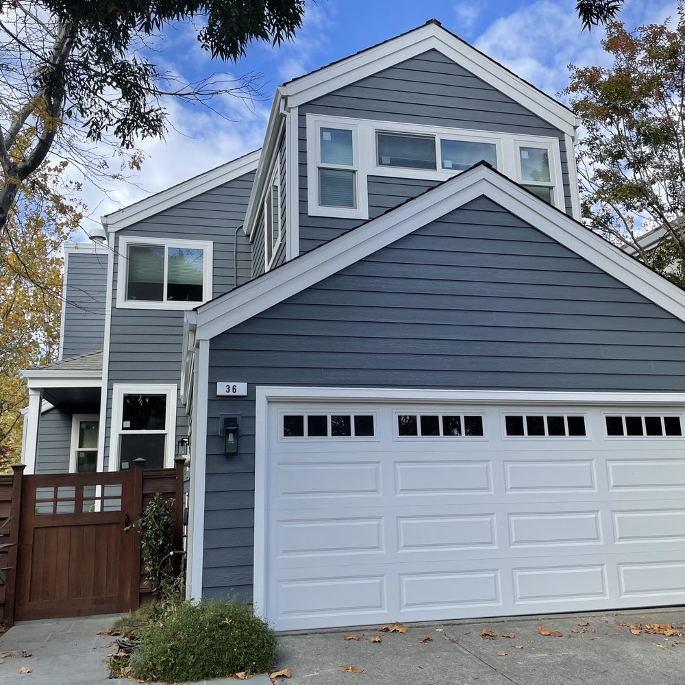 After: Front with new siding, trim, and windows