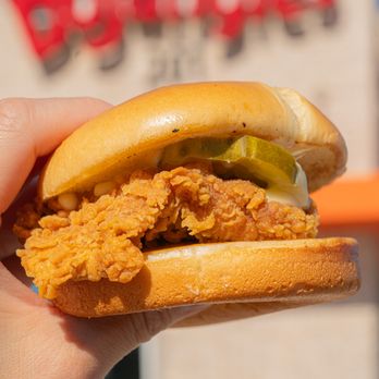 Bojangles - a hand holding a chicken sandwich - Fast Food Near Me - Euless, Texas