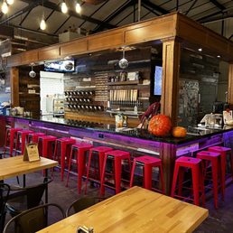 a bar with red stools a bar with red stools