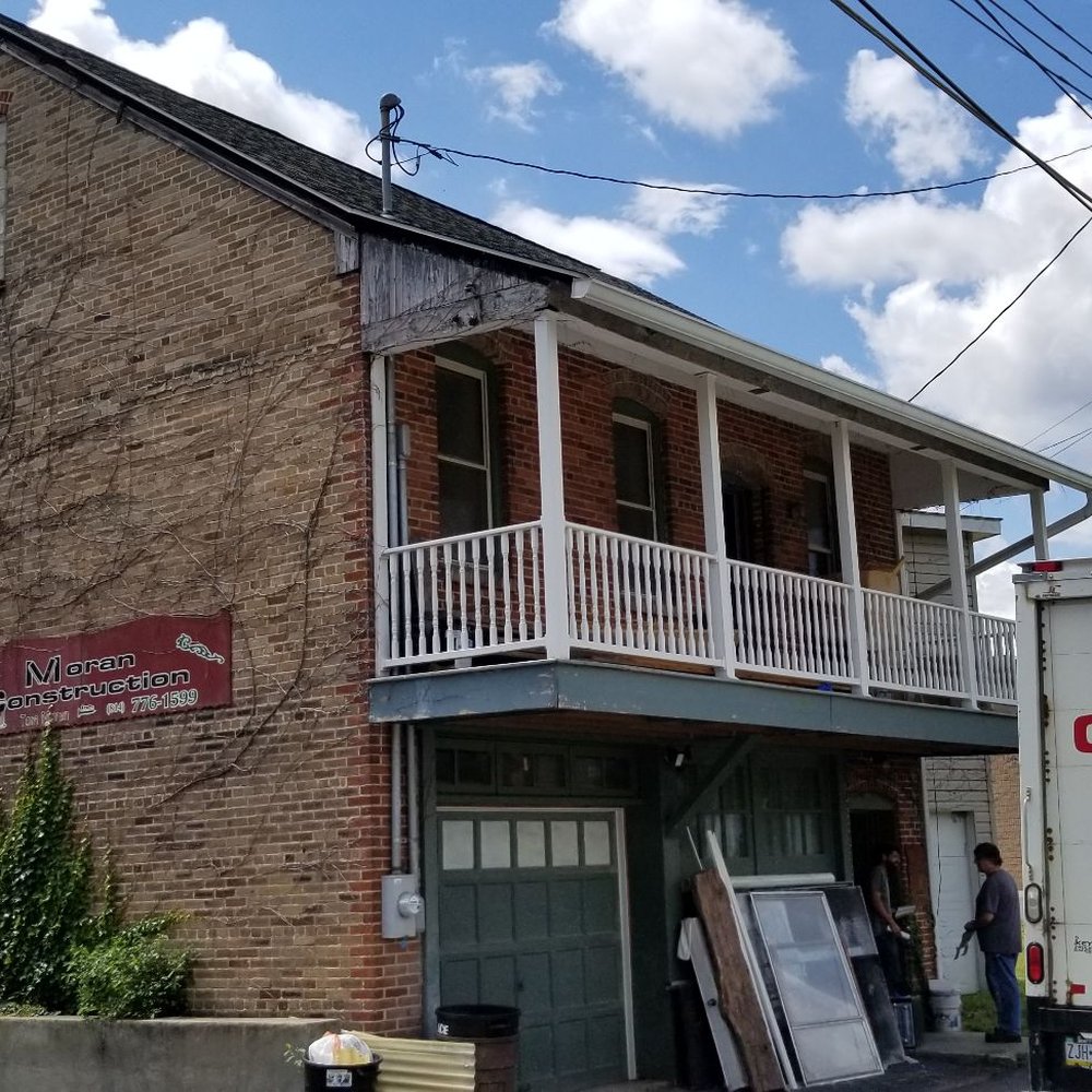 Moran Construction - a moving truck parked in front of a building - General Contractors Near Me - Ridgway, Pennsylvania