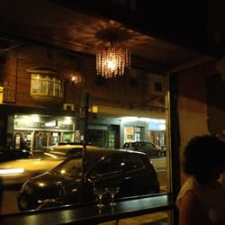 Joe's Shoe Store - Lovely old fashioned champagne glasses in the front window under a darling chandelier looking out on high.... n_n