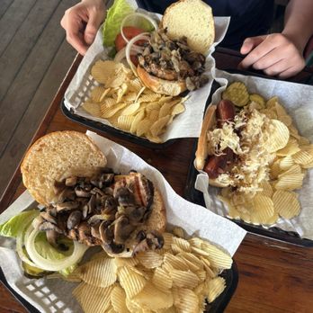 Skinny Legs Bar and Grill - Jerk Chicken Sandwich with the works  Sauerkraut Hotdog - Burgers Near Me - St John, Virgin Islands