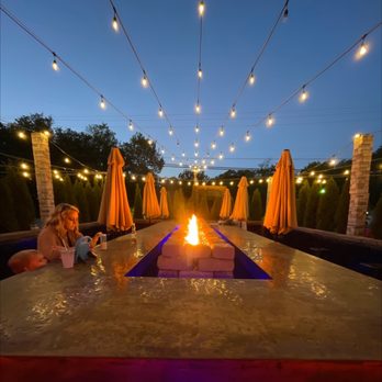 Mile High Tavern - a woman sitting by a fire pit - Burgers Near Me - Beech Mountain, North Carolina Mile High Tavern - a woman sitting by a fire pit - Burgers Near Me - Beech Mountain, North Carolina