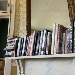a fireplace with books on it a fireplace with books on it