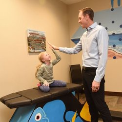 Dawson Chiropractic - Chiropractor Dr. Jerod Dawson high fives a young patient