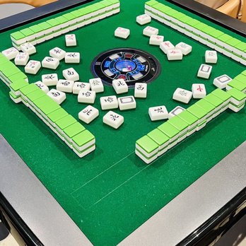 Utopia Dream Cafe - a game of domino on a table - Coffee & Tea Near Me - Markham, Ontario