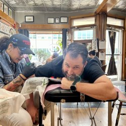 Ghost Light Tattoo Parlor - My husband getting work done by Yasmeena