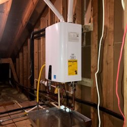 Katy Water Heaters - Navien NPE-240A Natural Gas .99 Energy Factor High Efficiency Condensing Tankless Water Heater installed in an upstairs attic