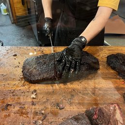Brisket being cut and weighed Brisket being cut and weighed