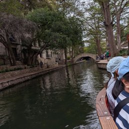 View of the river walk and San Antonio river from a tour boat. View of the river walk and San Antonio river from a tour boat.