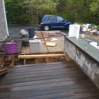 Capizzi Home Improvement - Memorial day  weekend with deck torn apart and kit strewn across driveway patio and lawn - General Contractors Near Me - Cotuit, Massachusetts