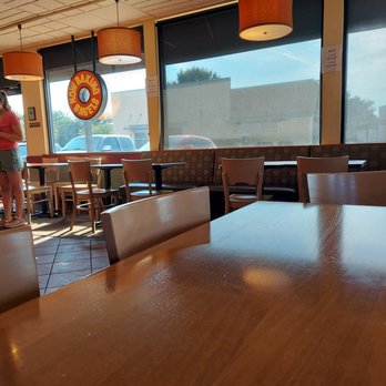 Einstein Bros. Bagels - a woman standing in a restaurant - Bagels Near Me - Mansfield, Texas