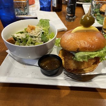 Frigate's Waterfront Bar and Grill - Macadamia and coconut crusted grouper sandwich, with a Caesar side salad - Seafood Near Me - Melbourne, Florida