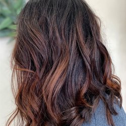 Blushing Beauty Studio - Brunette hair color enhanced with copper-red highlights.