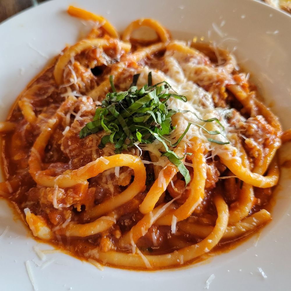 Epulo Bistro - a plate of pasta with sauce and parmesan cheese - Modern European Near Me - Edmonds, Washington Epulo Bistro - a plate of pasta with sauce and parmesan cheese - Modern European Near Me - Edmonds, Washington