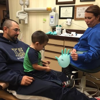 Chad Tomazin - A great, first time ever, even able to sit on Dad's lap. And that chicken glove sure helped make it a "piece of cake". - Cosmetic Dentists Near Me - Riverside, California