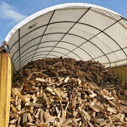 Seasoned firewood kept covered.