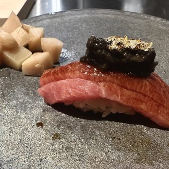 Sora Omakase - Caviar with gold leaf on top of fresh Abalone and side pickled ginger bites - Sushi Bars Near Me - Stony Brook, New York Sora Omakase - Caviar with gold leaf on top of fresh Abalone and side pickled ginger bites - Sushi Bars Near Me - Stony Brook, New York