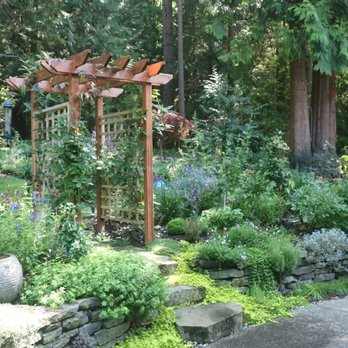 Gray's Landscaping - After - dry stone wall with steps and a custom trellis arch. Plus planting that looks great year round. - Landscaping Near Me