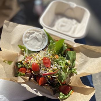 Opolis - a person holding a salad in a paper bag - Music Venues Near Me - Norman, Oklahoma Opolis - a person holding a salad in a paper bag - Music Venues Near Me - Norman, Oklahoma