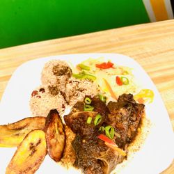 Auntys Jamaican Kitchen - Oxtails on a bed of Rice and peas with stir fried Cabbage and sweet plantains.