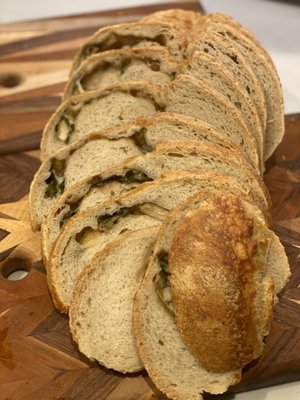 Photo of CroBean - Alpine, CA, US. Gruyere cheese and green onion loaf sliced. Made and incredible sandwich