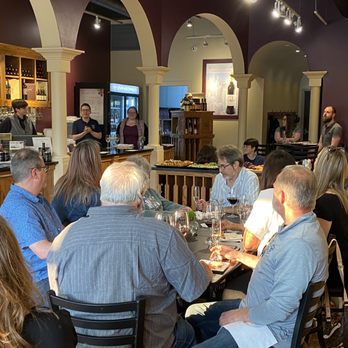 Lynfred Winery - a group of people sitting around a table - Wine Tasting Room Near Me - Highland Park, Illinois