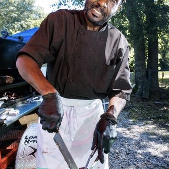 Snack Bar - a man cutting up a piece of meat - Barbeque Near Me - Hilton Head Island, South Carolina Snack Bar - a man cutting up a piece of meat - Barbeque Near Me - Hilton Head Island, South Carolina