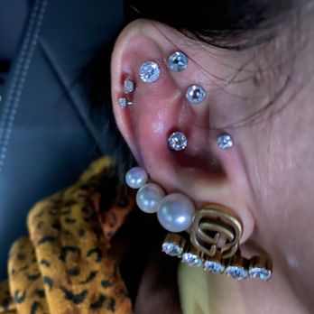 Laughing Buddha Body Piercing - Tragus, inner conch, forward helix and cartilage piercings done at Laughing Buddha by AJ - Piercing Near Me - Upland, California