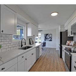 Quality Granite & Cabinets - narrow kitchen layout remodel with soffit, dark fixtures and black cabinet handles, subway backplash