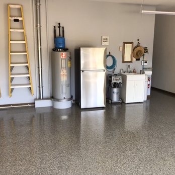 Austin Epoxy Floors - a garage with a ladder and refrigerator - Flooring Near Me Austin Epoxy Floors - a garage with a ladder and refrigerator - Flooring Near Me