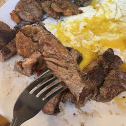 Steak and eggs with smashed potatoes. This was supposed to be a MR steak. Steak and eggs with smashed potatoes. This was supposed to be a MR steak.