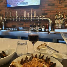 At the Bar, pasta with mussels, glass of Pino and Stanley Tucci in Italy. Heaven.